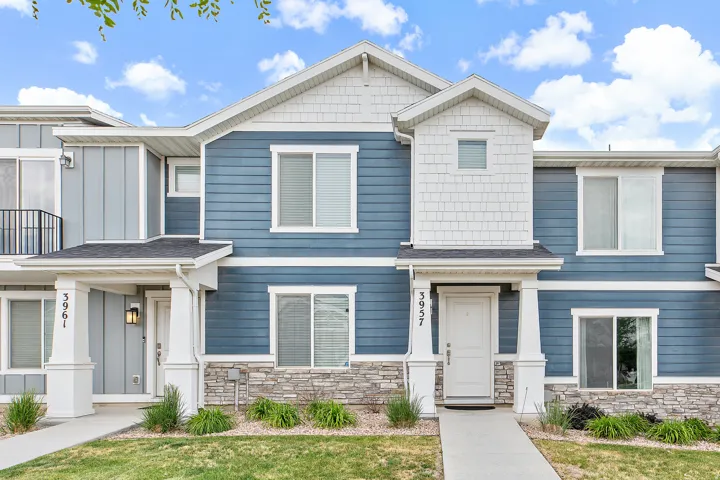 Contemporary townhouse exterior featuring blue horizontal siding and white trim