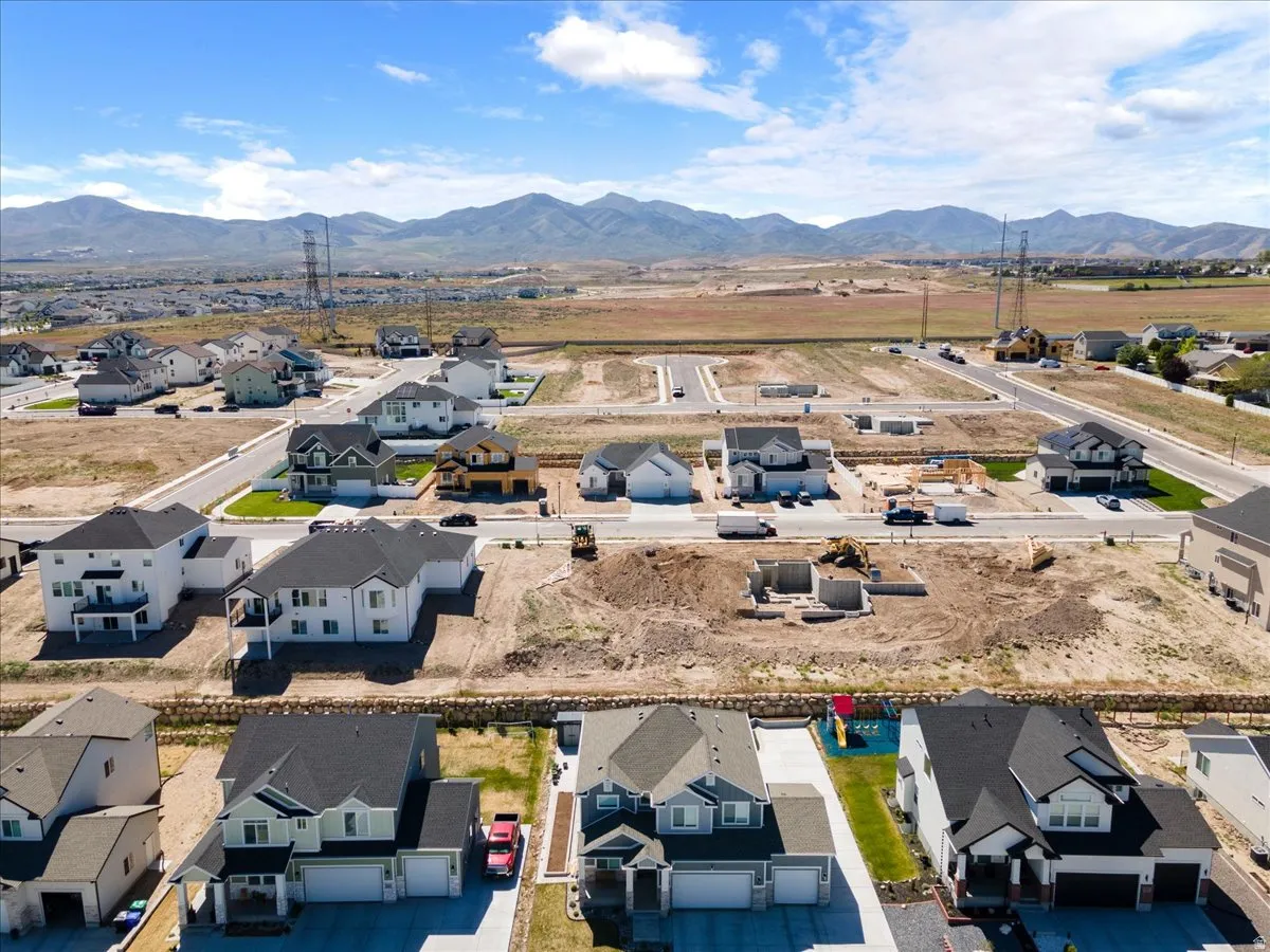 Aerial perspective showcasing a developing community with established homes and new construction