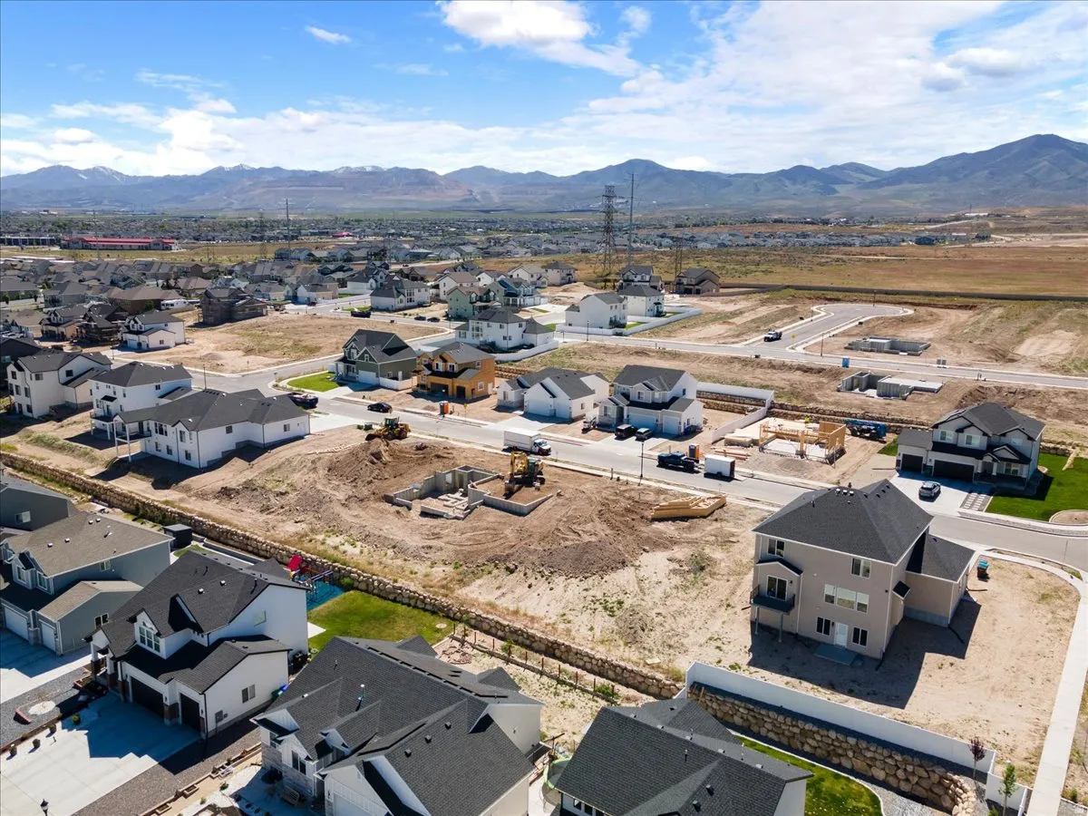Aerial perspective showcasing a developing residential area with mountains in the background