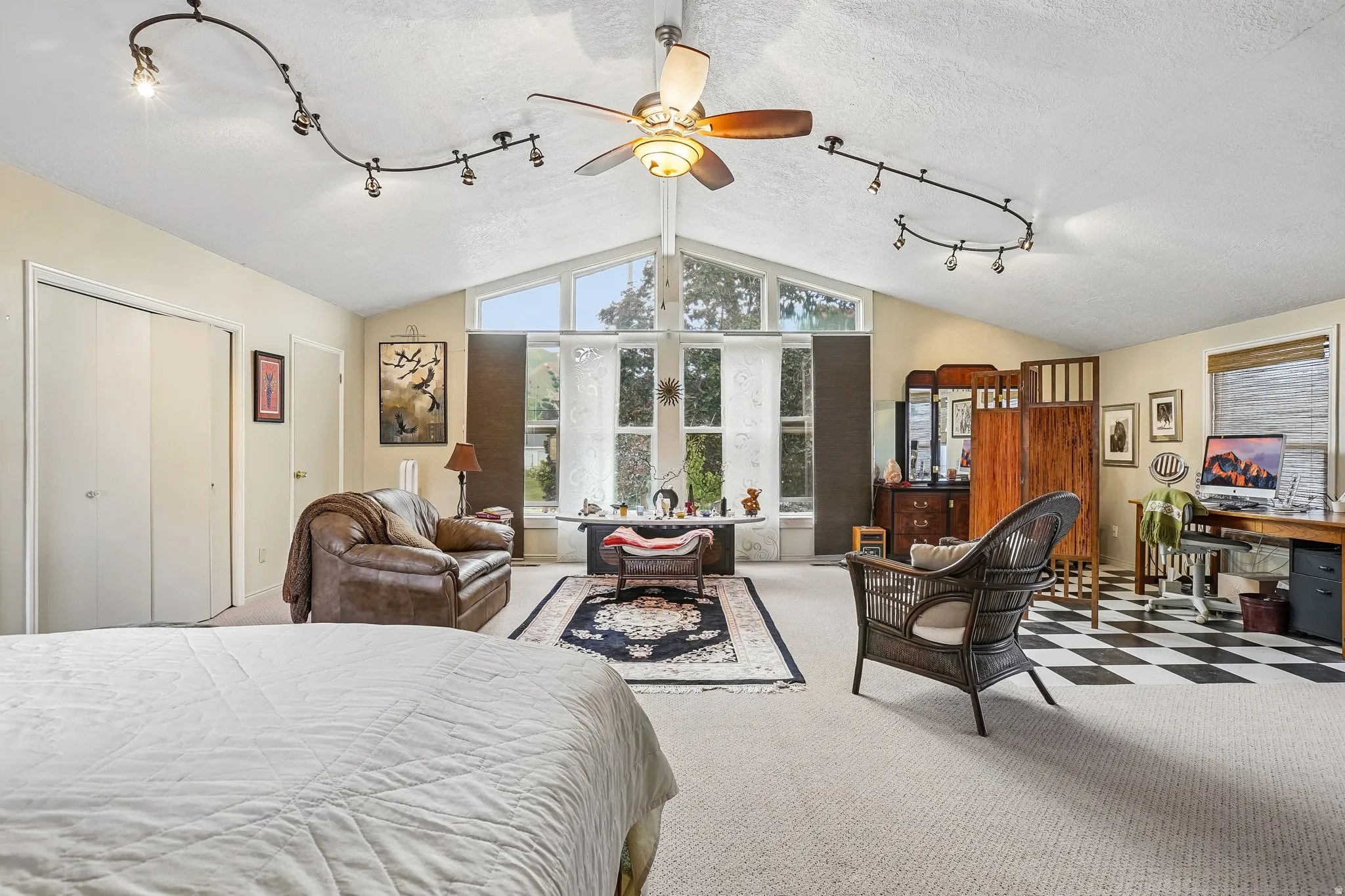 Primary bedroom with vaulted ceilings, large windows for views and natural light