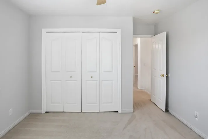 Neutral-toned carpeting and light gray walls create a versatile interior
