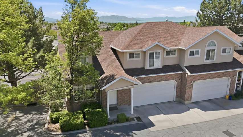 Brick and stucco exterior with multiple gables and a multi-pitch roof