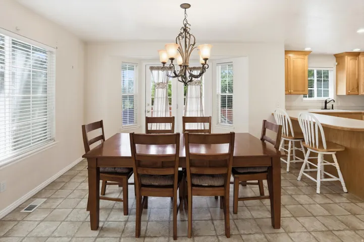 Dining area featuring a decorative chandelier and tiled flooring