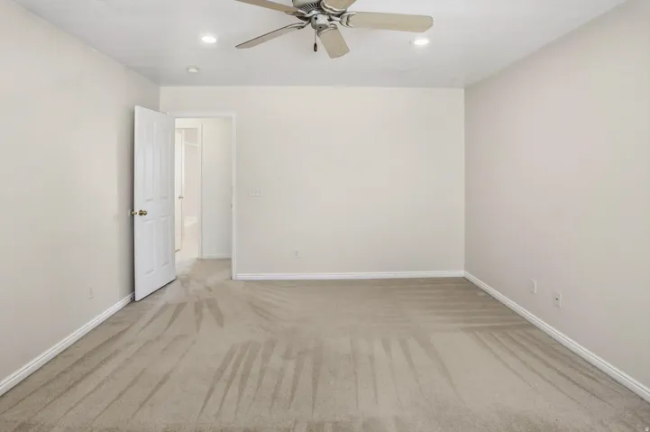 Spacious room featuring neutral carpeting and light-toned walls