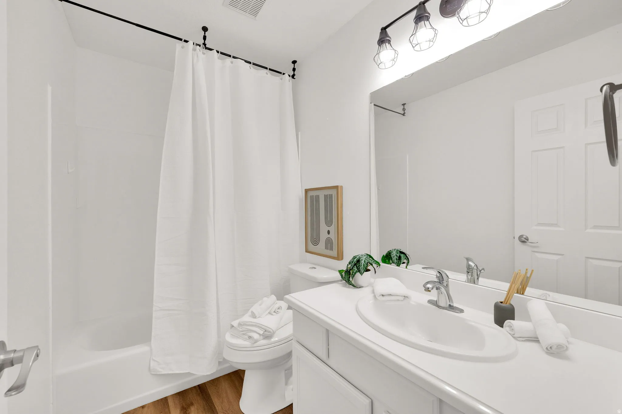 Bathroom featuring a single vanity with a white countertop, chrome faucet, and integrated sink