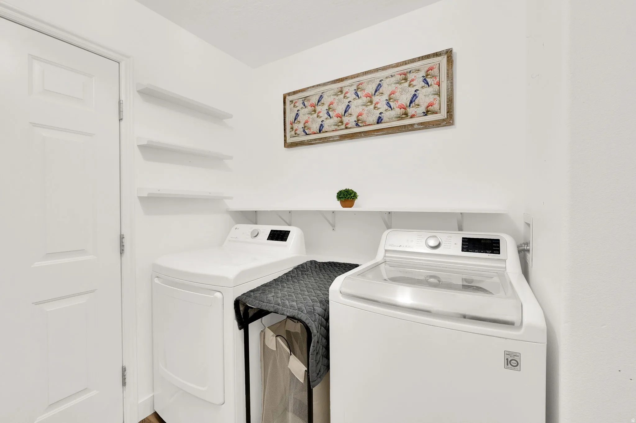Dedicated laundry area featuring a white paneled door