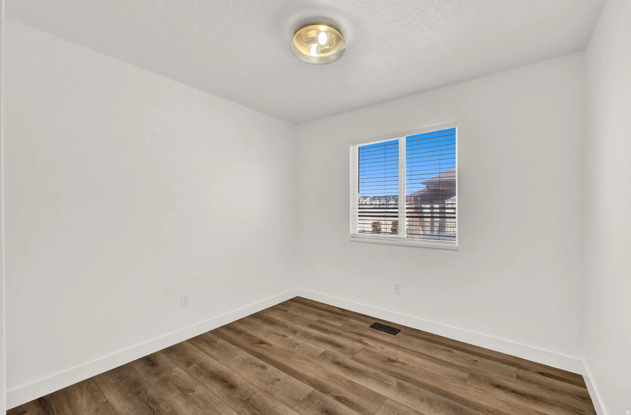 Neutral white walls with wood-finish flooring