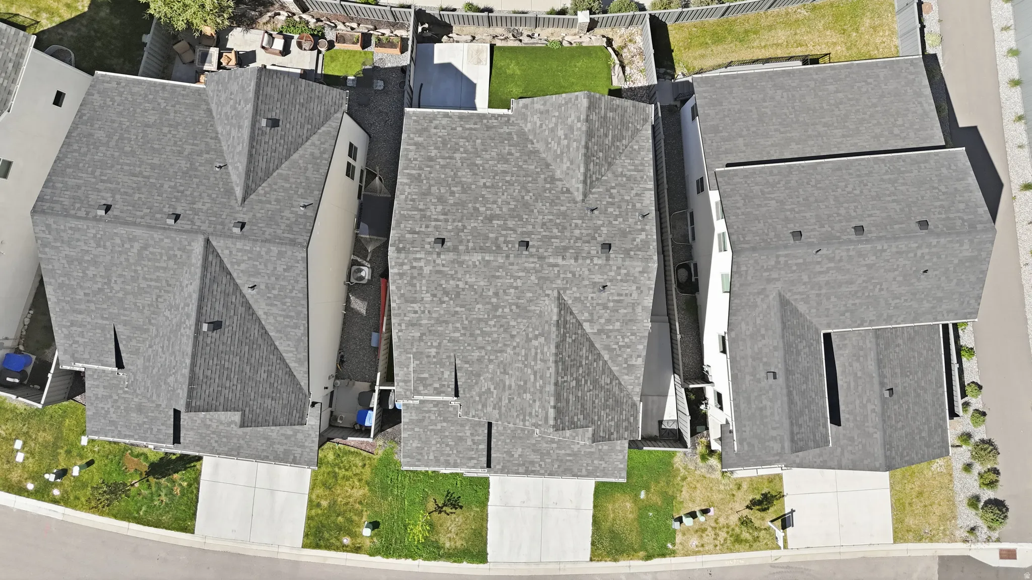 Aerial view of a residential property featuring a gray asphalt shingle roof