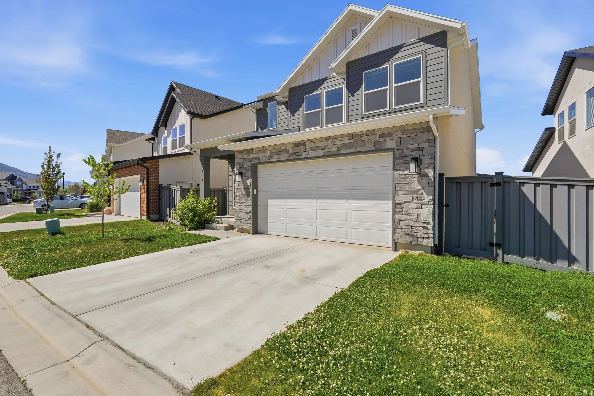 Contemporary two-story residence featuring a combination of stone veneer and siding facade