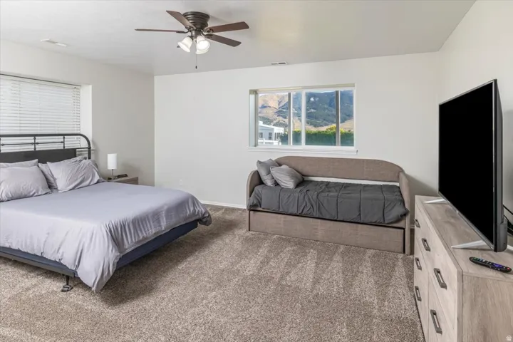 Spacious room featuring neutral carpeting and light-toned walls