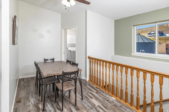 Open dining area featuring wood-finish flooring and a ceiling fan
