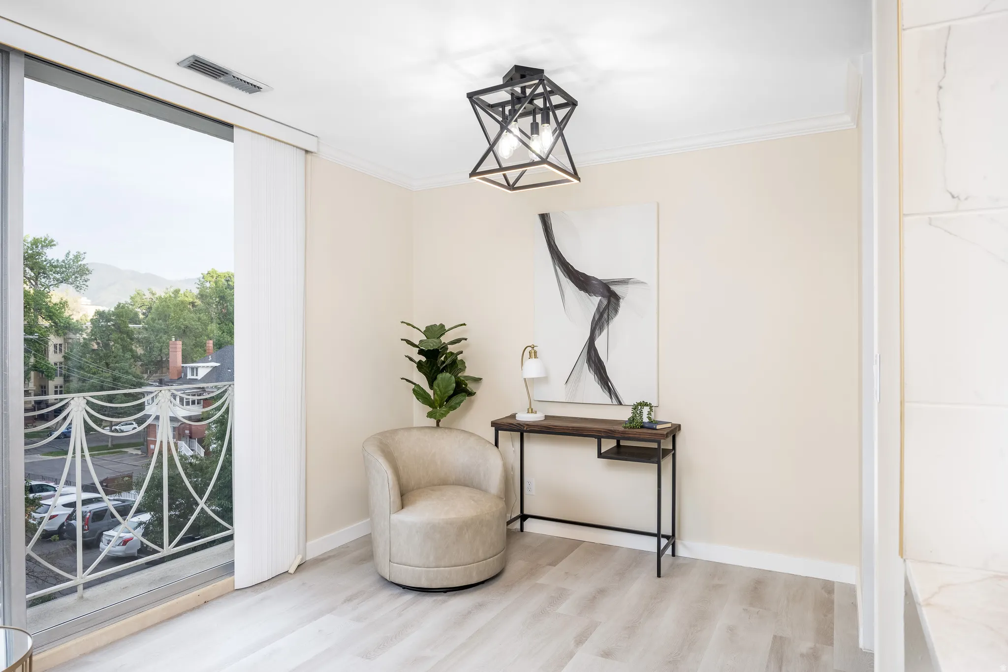 Sliding glass door with balcony access and decorative railing