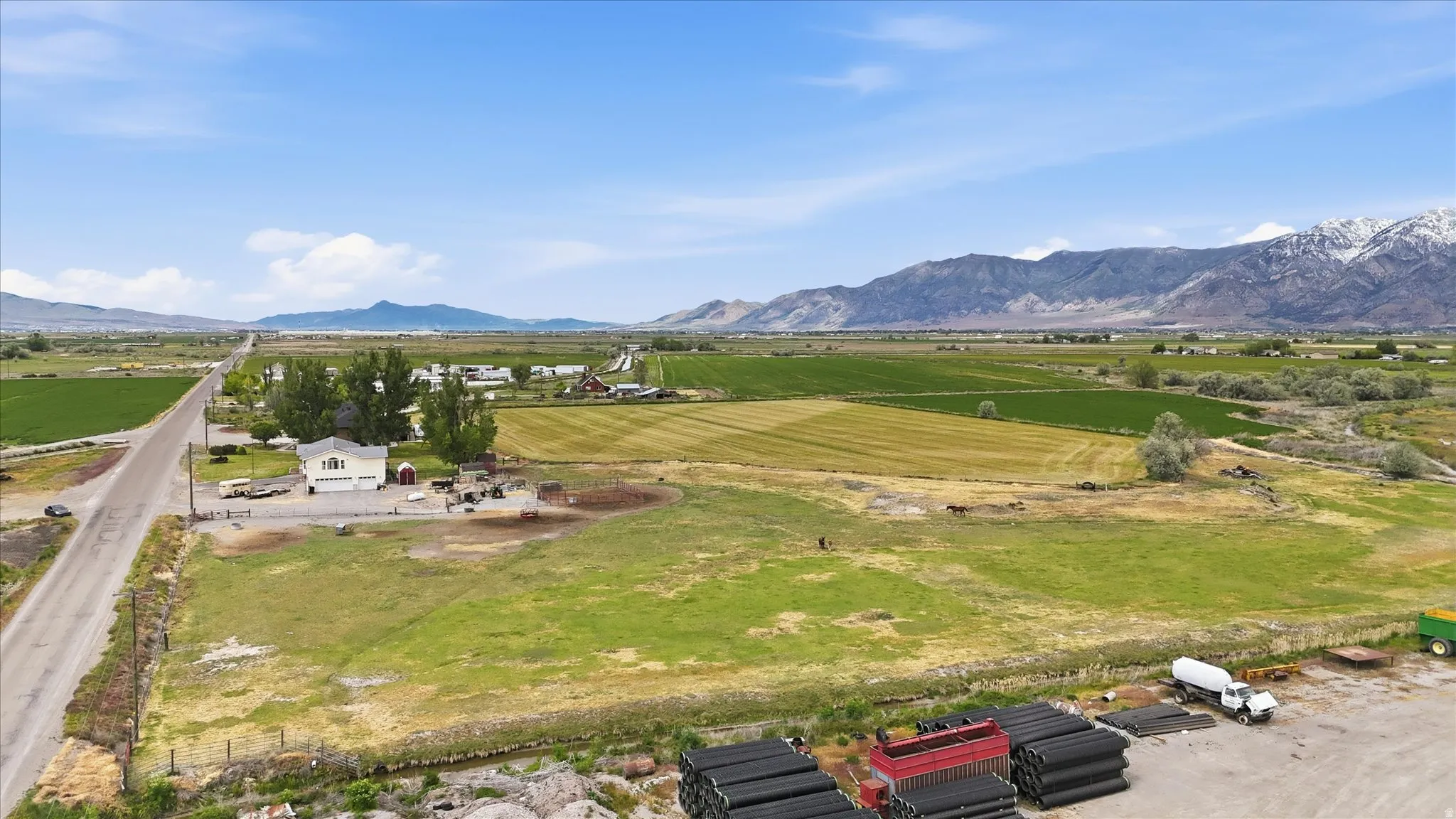Expansive rural property featuring a residence with an attached three-car garage