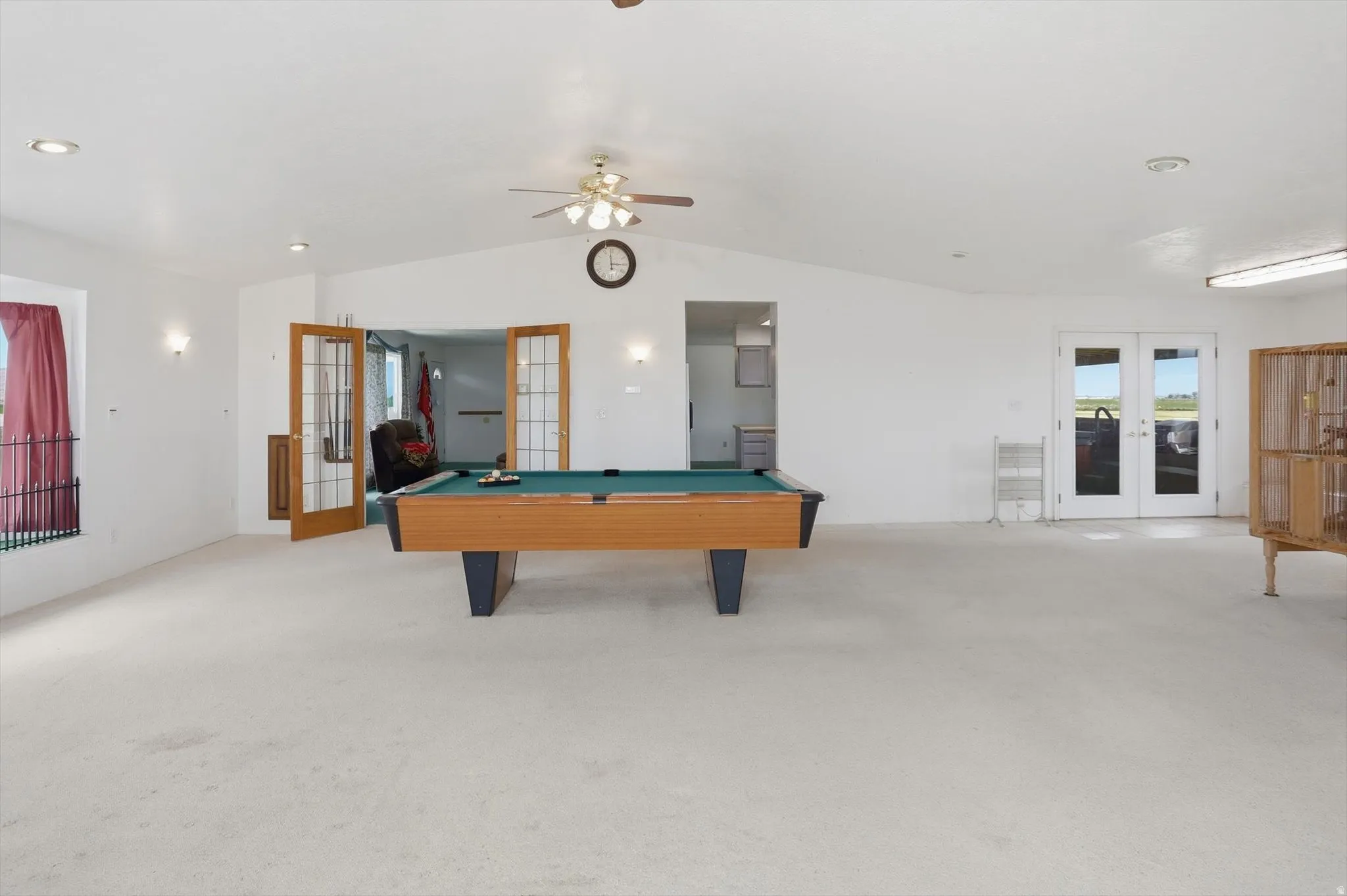 Spacious room with vaulted ceilings and recessed lighting