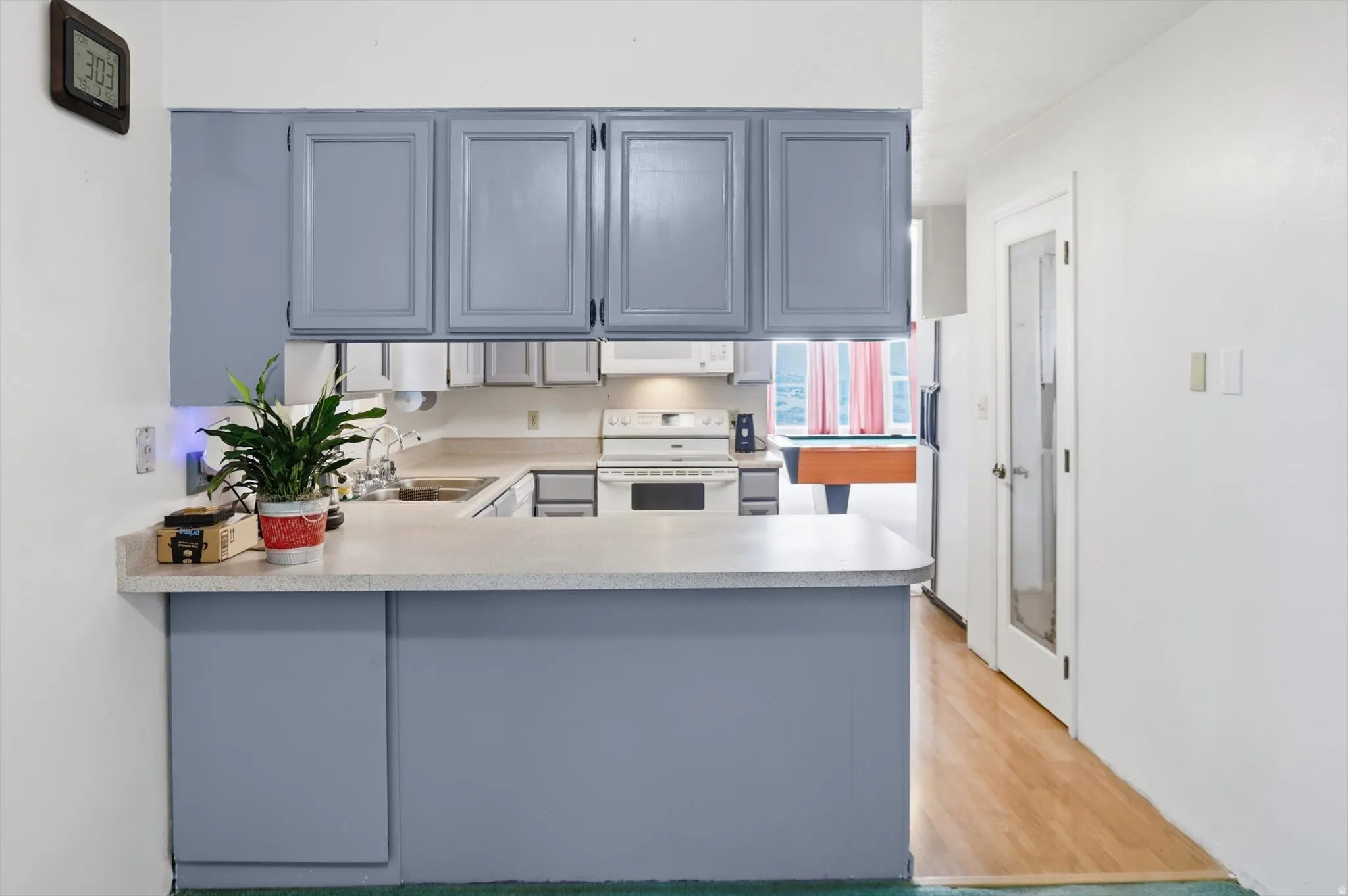 Kitchen featuring blue-painted cabinetry and an integrated breakfast bar
