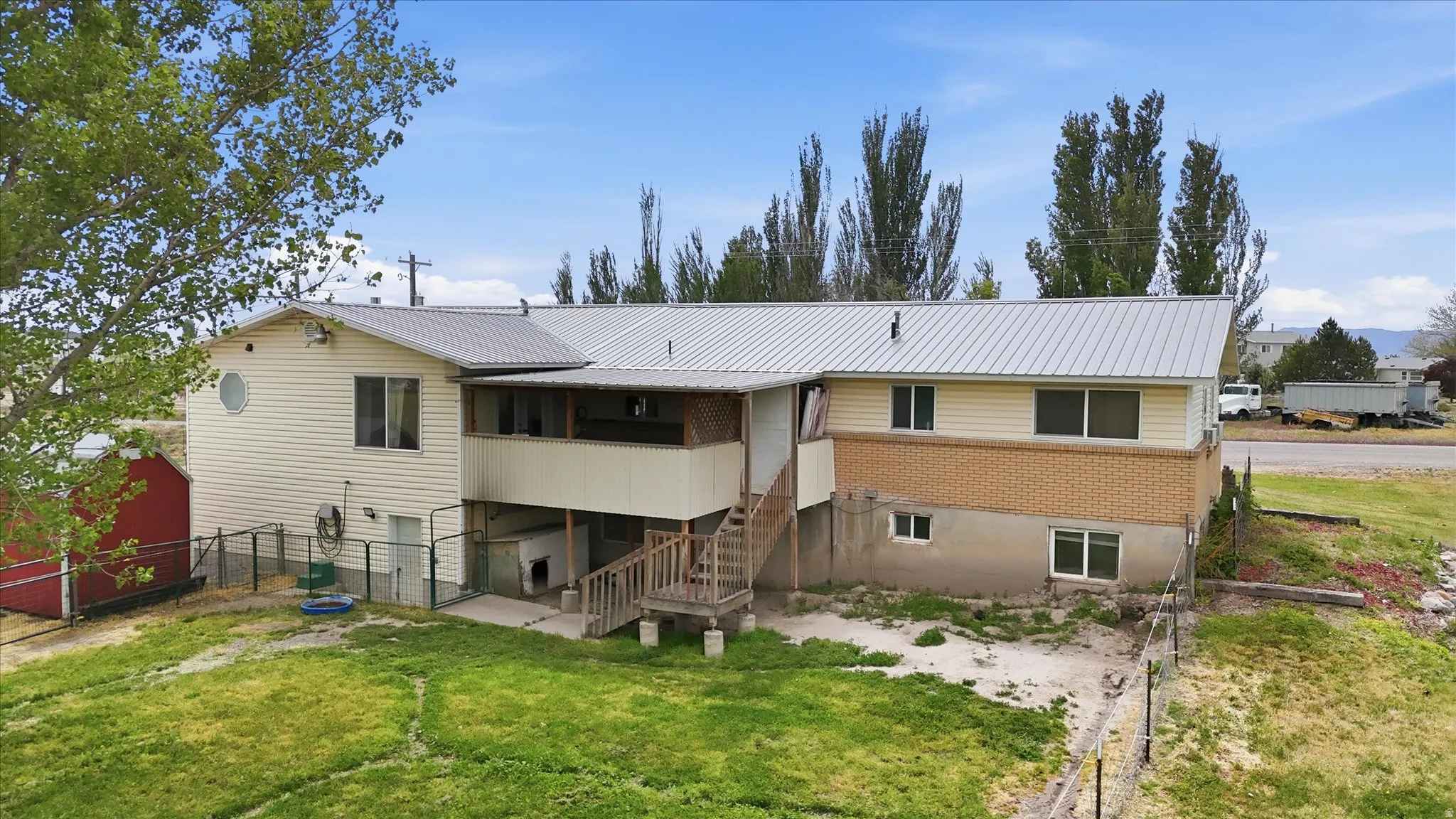 Rear exterior featuring a deck and walkout basement