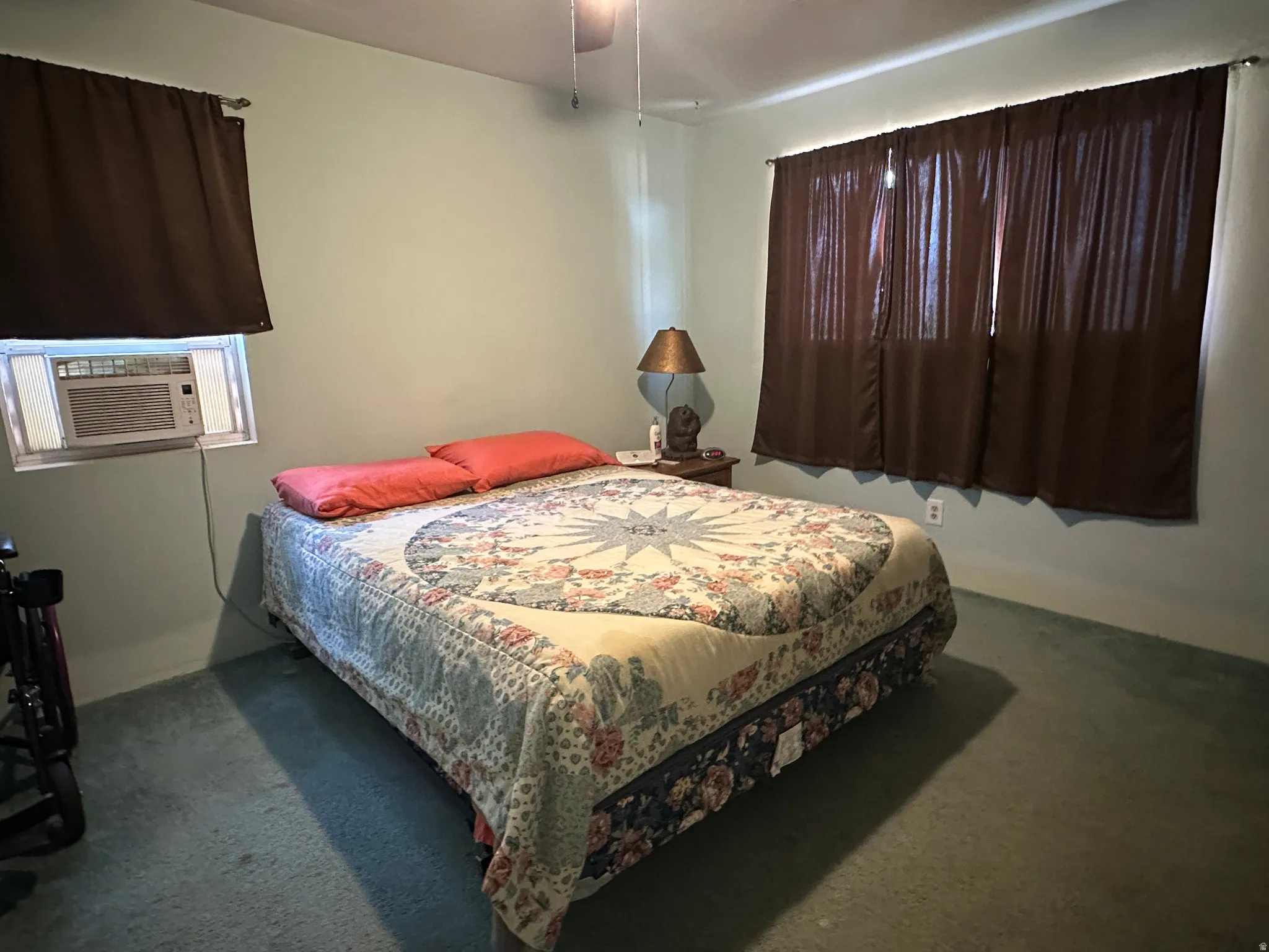 Room featuring wall-to-wall carpeting and a window-mounted air conditioning unit