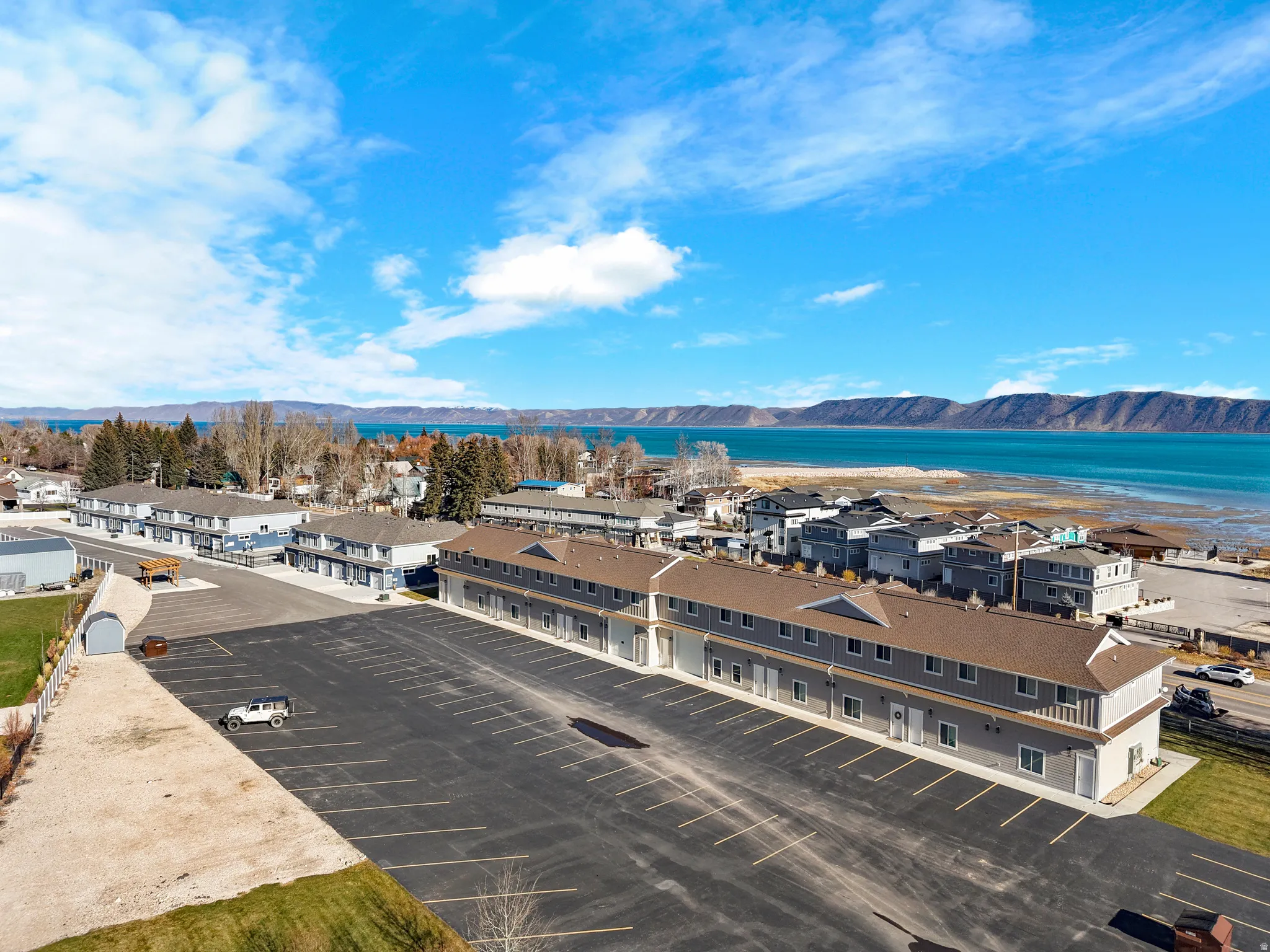 Expansive paved parking area with direct access to multiple residential buildings