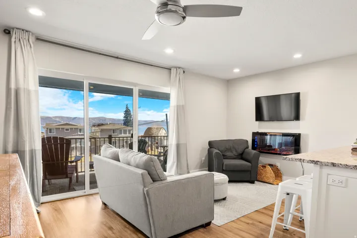 Bright living area with wood-finish flooring, recessed lighting, and a ceiling fan