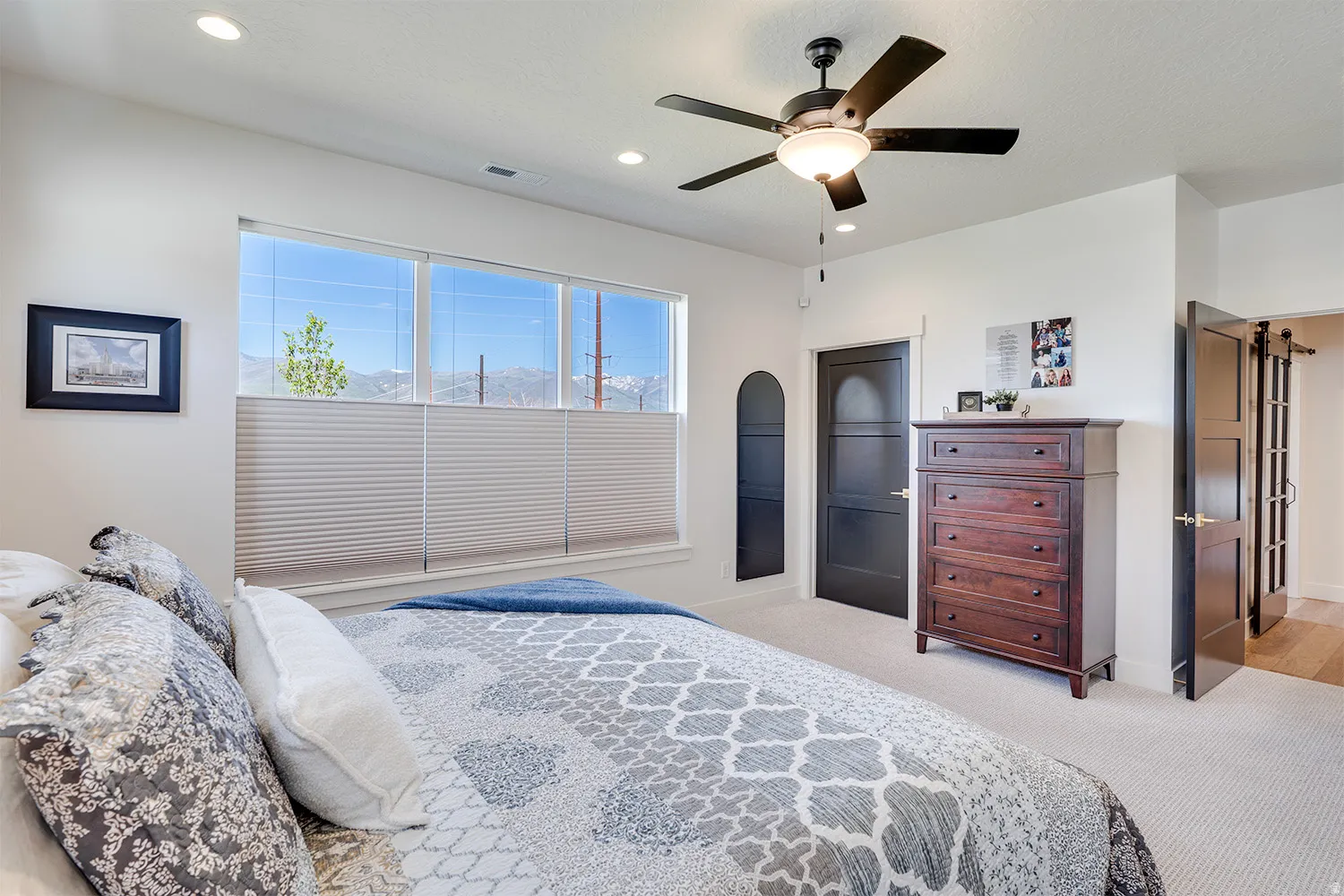 Spacious room featuring multiple windows with cellular shades, a ceiling fan with integrated lighting, and recessed lighting
