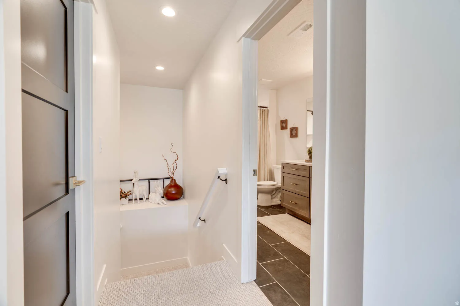 Hallway with recessed lighting and light-toned flooring