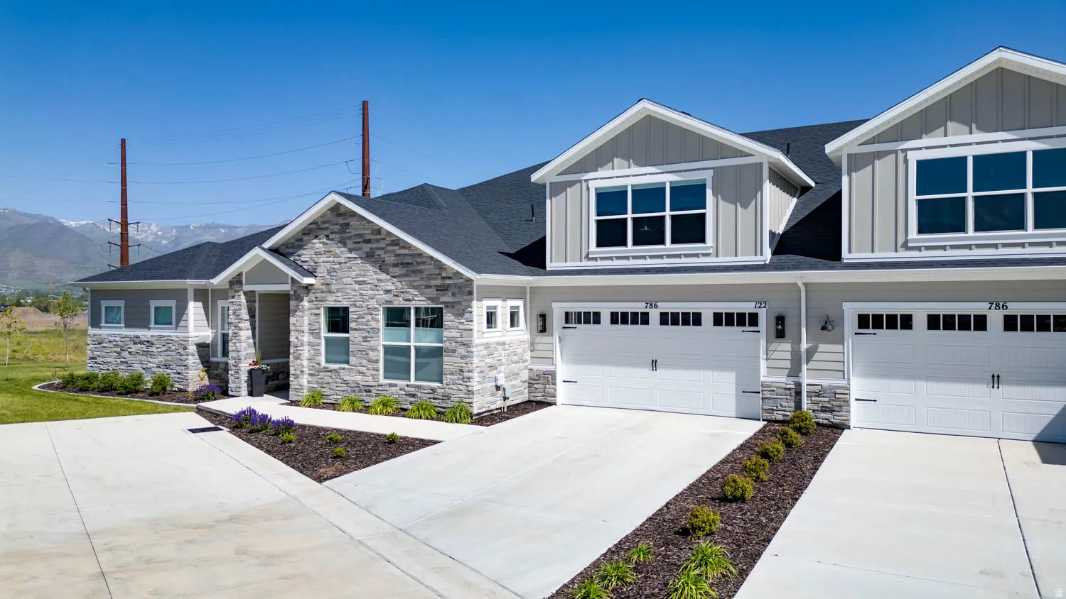Modern townhome exterior featuring stone veneer and horizontal siding