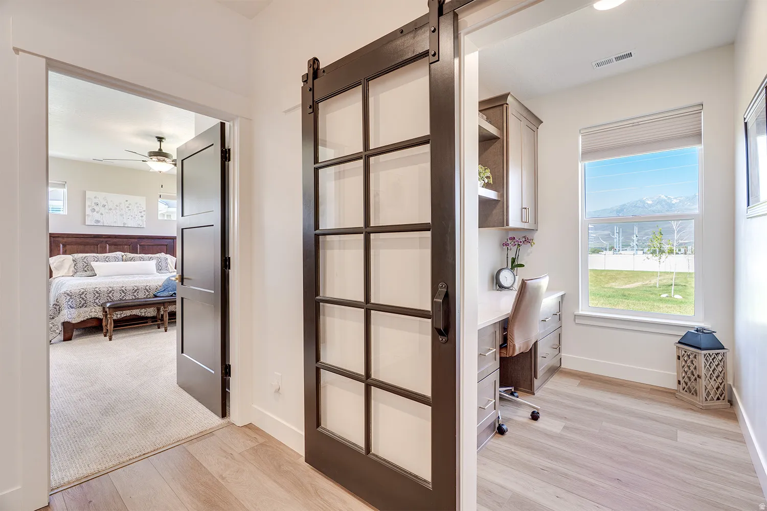 Sliding barn door with glass panes opening to a dedicated office space