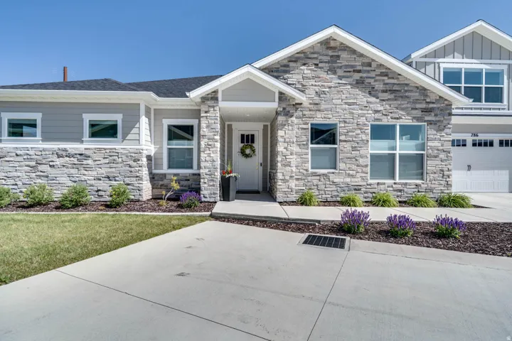 Contemporary facade featuring stone veneer and horizontal siding