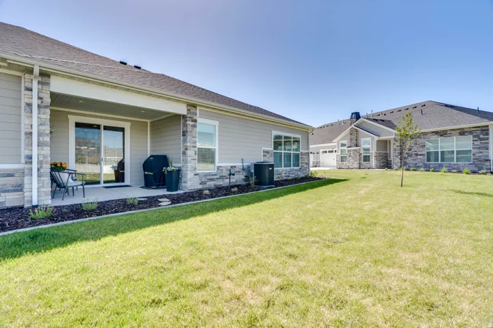 Rear exterior featuring a covered concrete patio with sliding glass door access