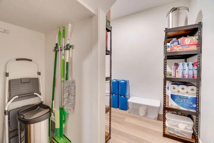 Dedicated storage area featuring robust metal shelving units and durable wood-finish flooring