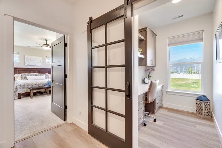 Sliding barn door with glass panes opening to a dedicated office space