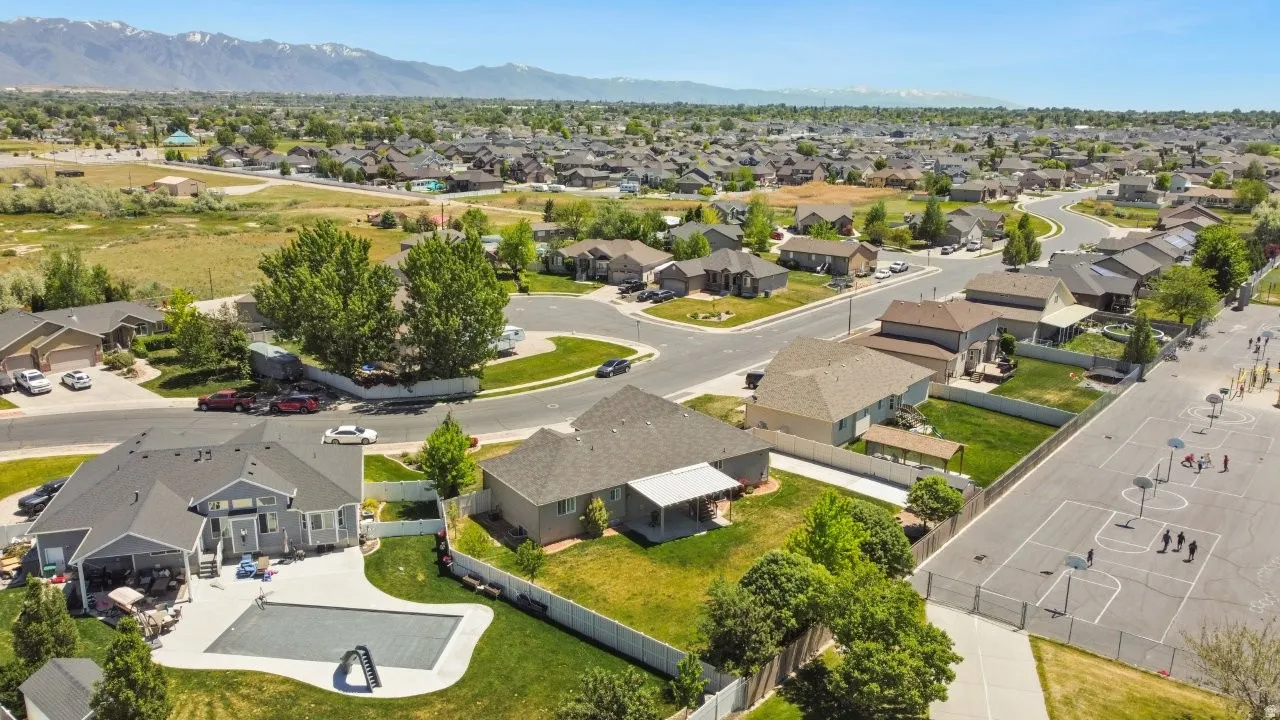 Aerial perspective showcasing a residential neighborhood with distant mountain ranges