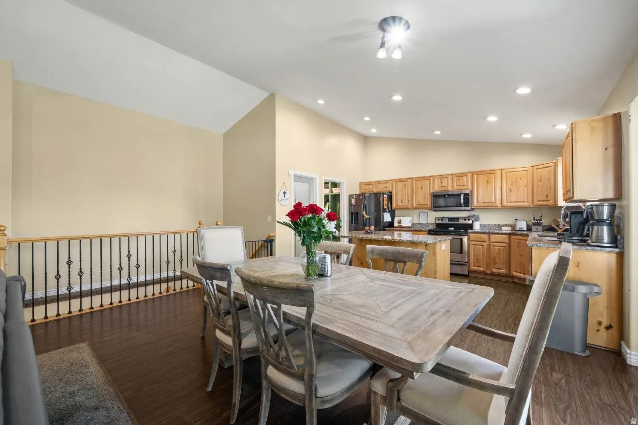 Open concept dining area featuring wood-finish flooring
