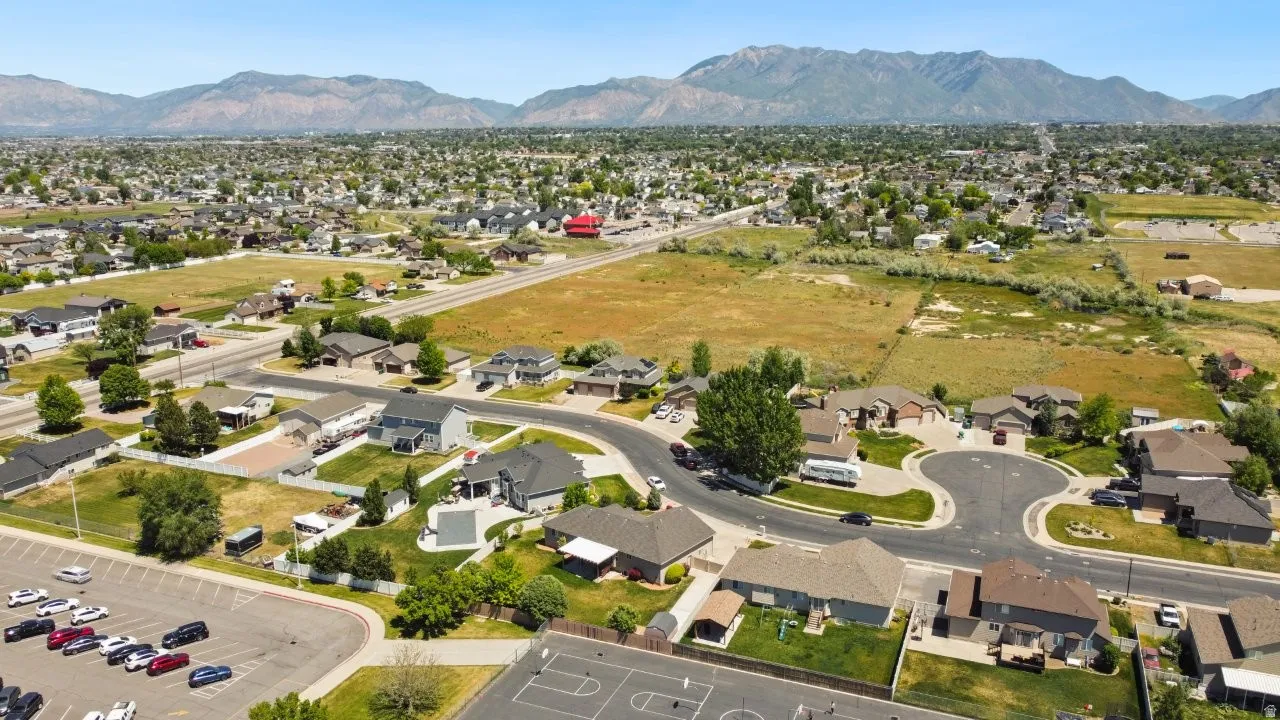 Residential neighborhood with cul-de-sac streets, established homes, and undeveloped land parcels