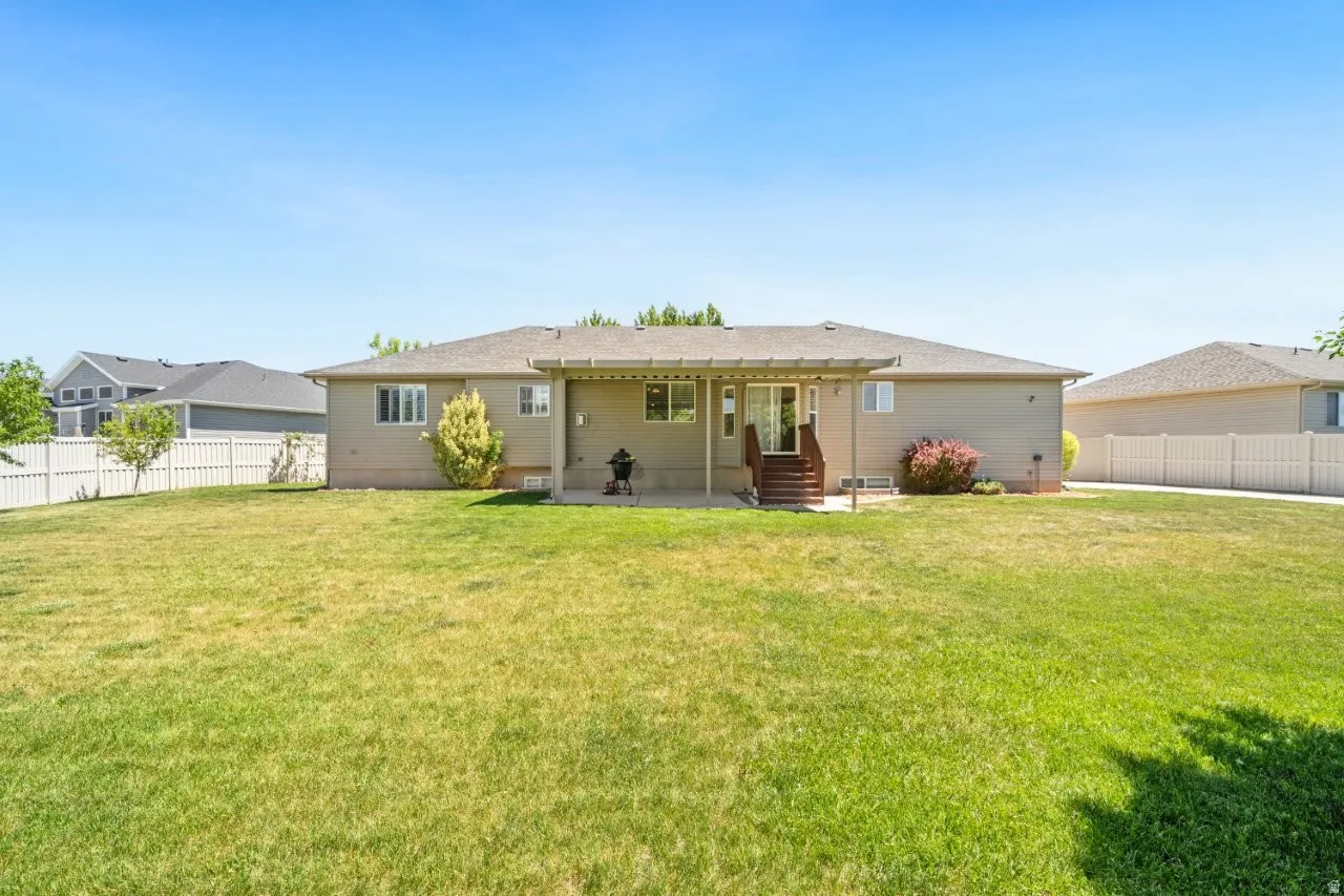 Expansive green lawn with a full vinyl privacy fence
