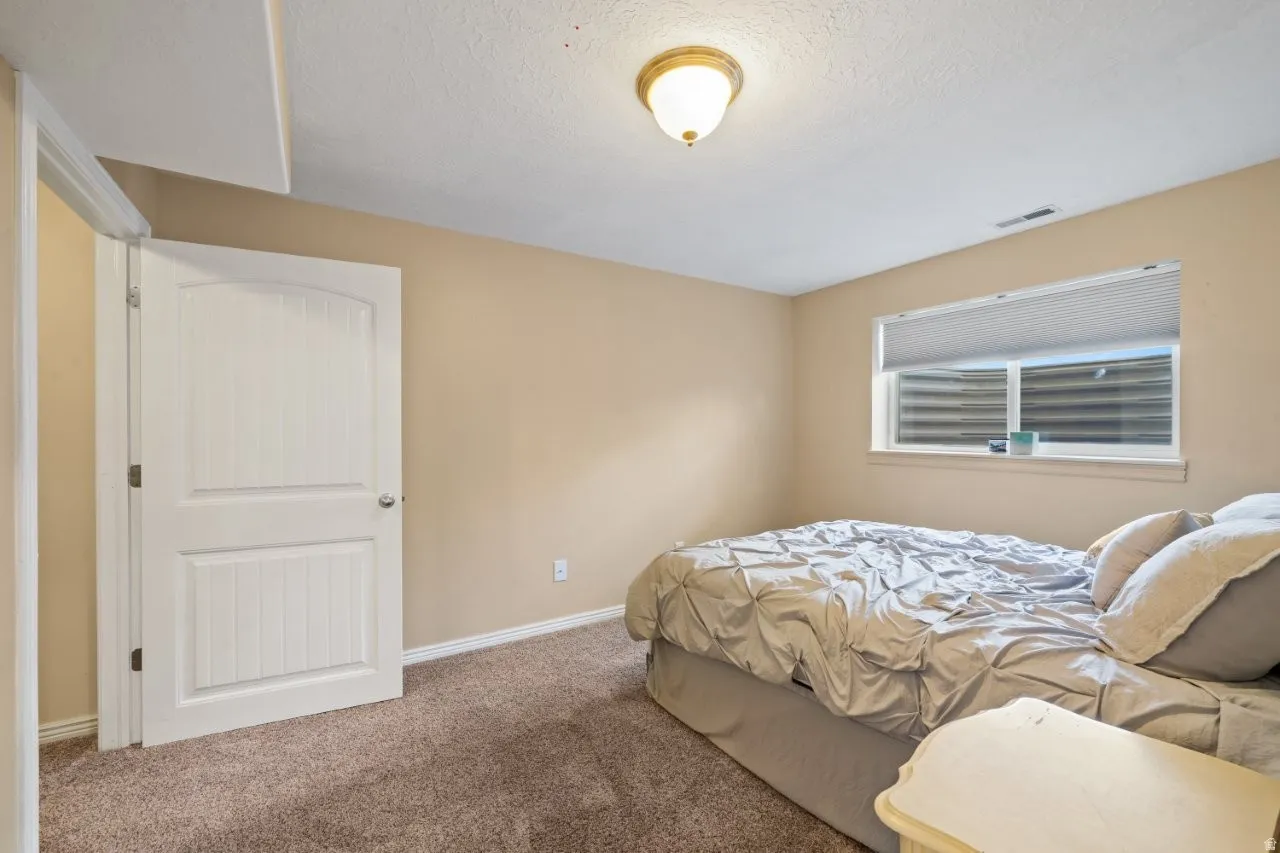 Neutral wall tones complement the durable carpet flooring