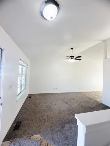Spacious interior with neutral-toned carpeting and bright white walls