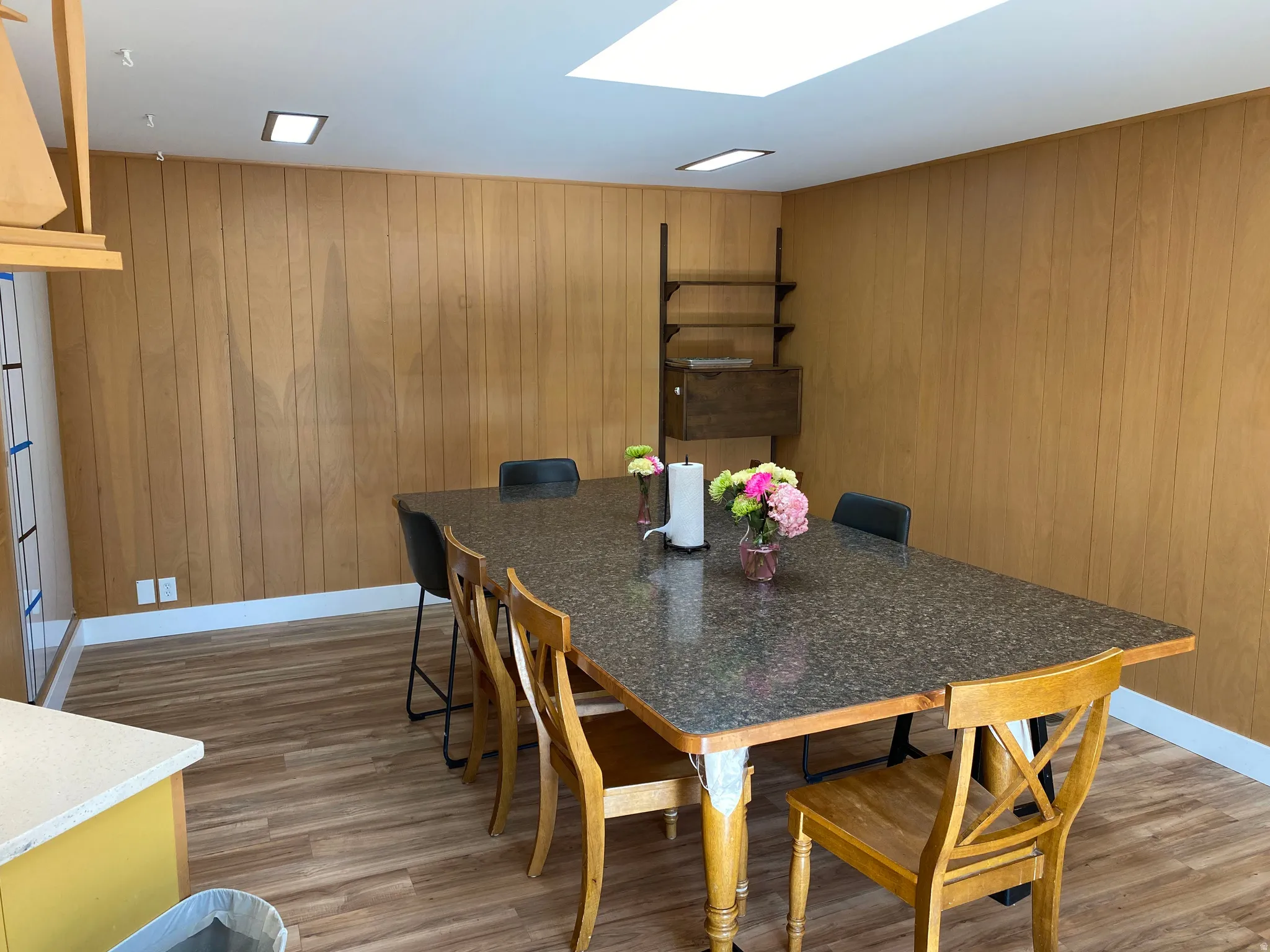 Dining area featuring wood-finish flooring and paneled walls