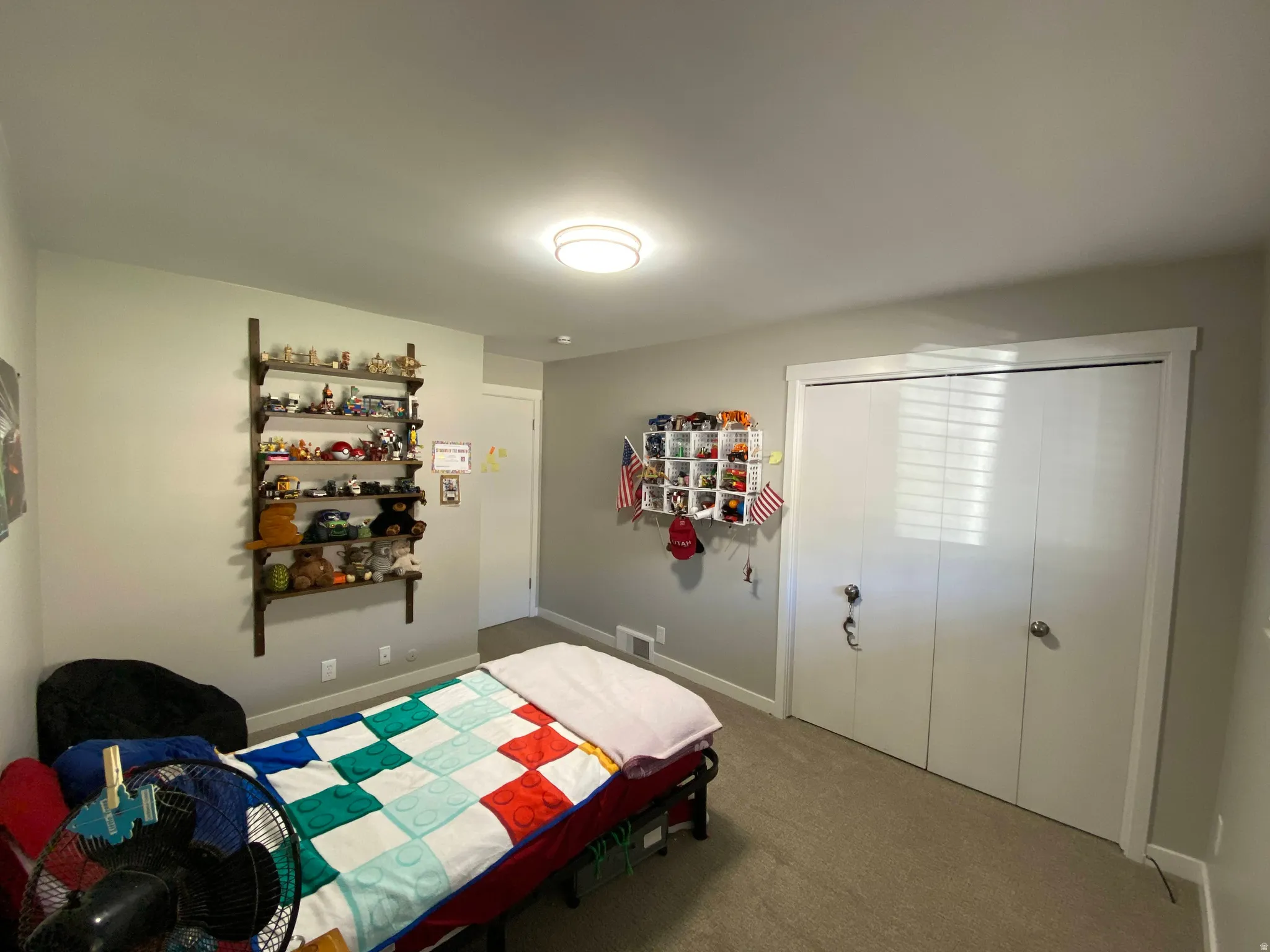 Room featuring neutral wall tones and textured carpeting