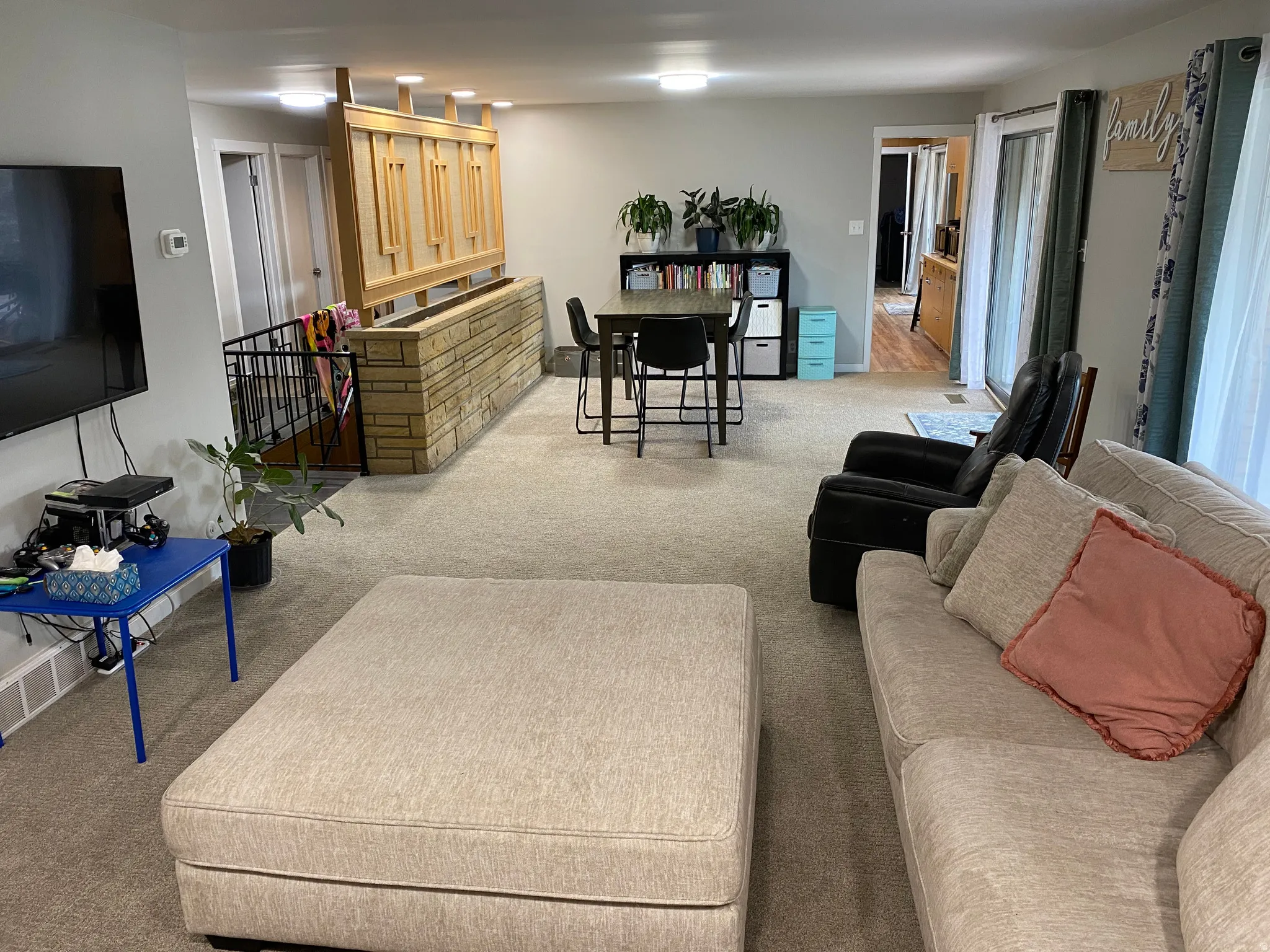 Open-concept living area with light-toned carpeting