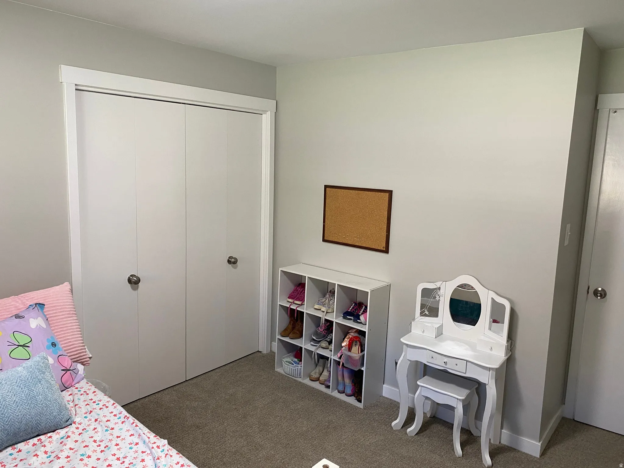 Neutral-toned walls and carpeted flooring define this room