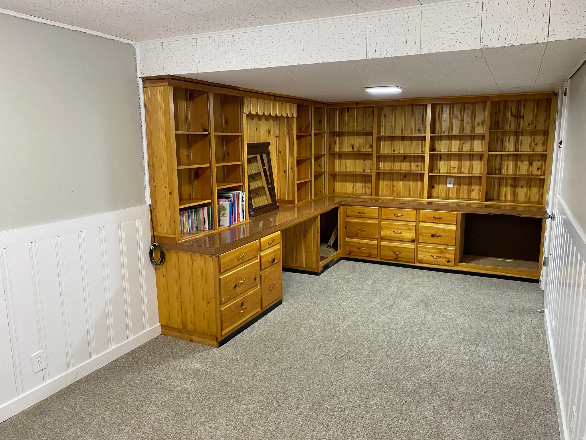 Extensive built-in wood cabinetry with integrated shelving and desk space