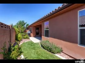 Exterior stucco wall with tile roofing and multiple windows