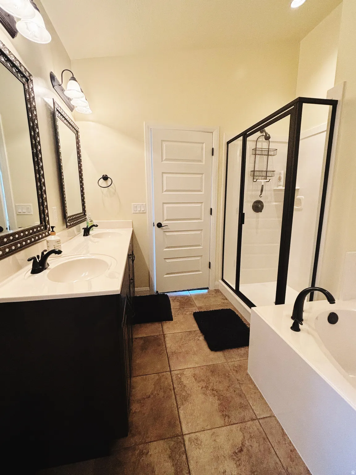 Dual vanity with white countertops, undermount sinks, and matte black fixtures