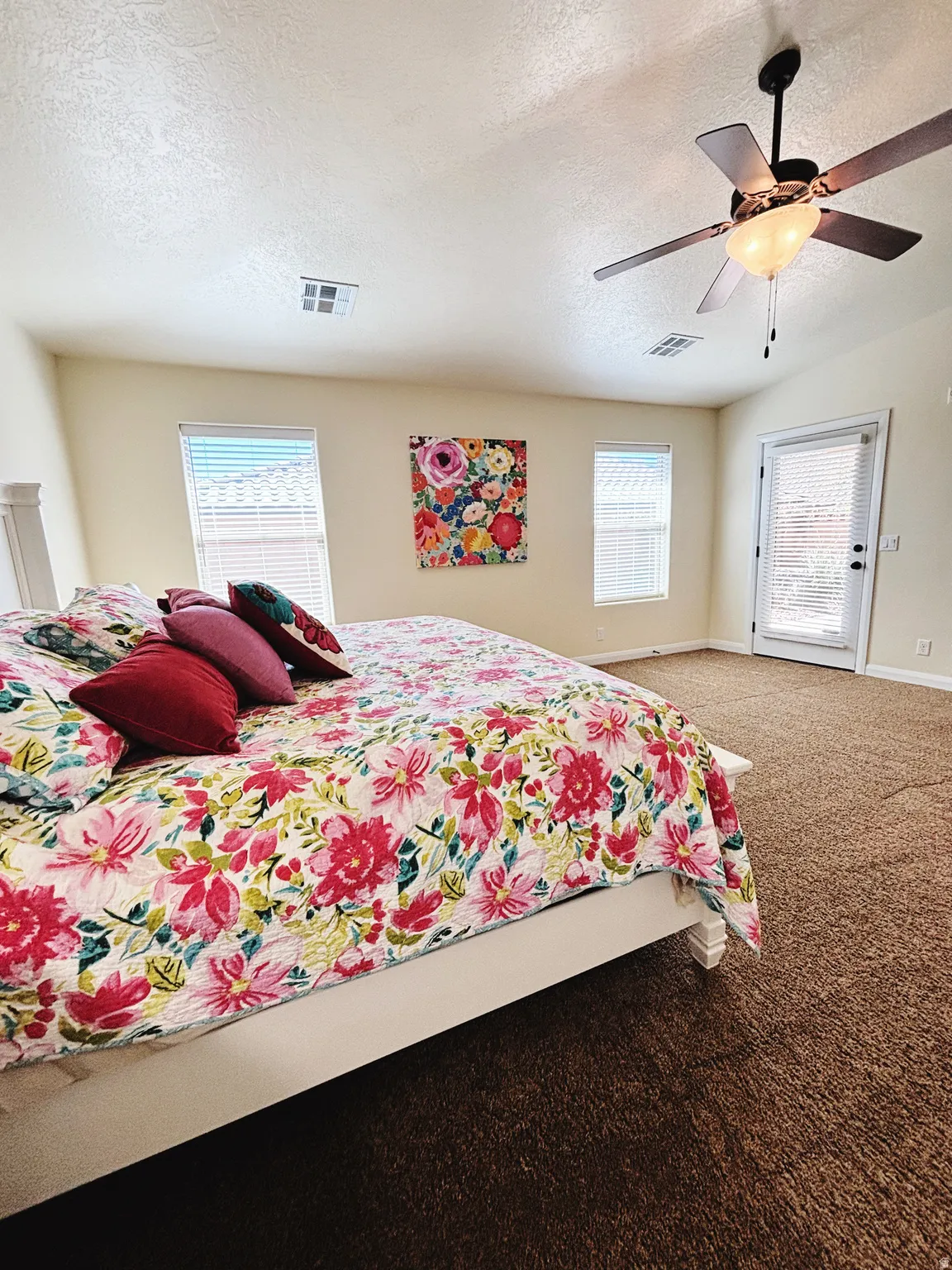 Spacious room with plush brown carpeting and light-toned walls