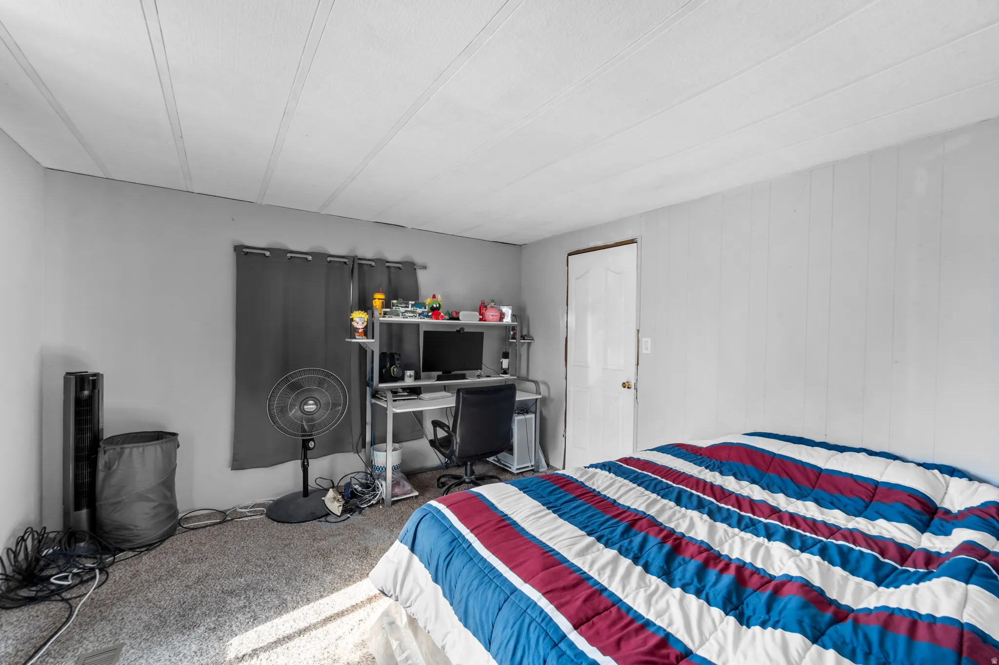 Room featuring gray wall paint, light-colored vertical paneling, and wall-to-wall carpeting
