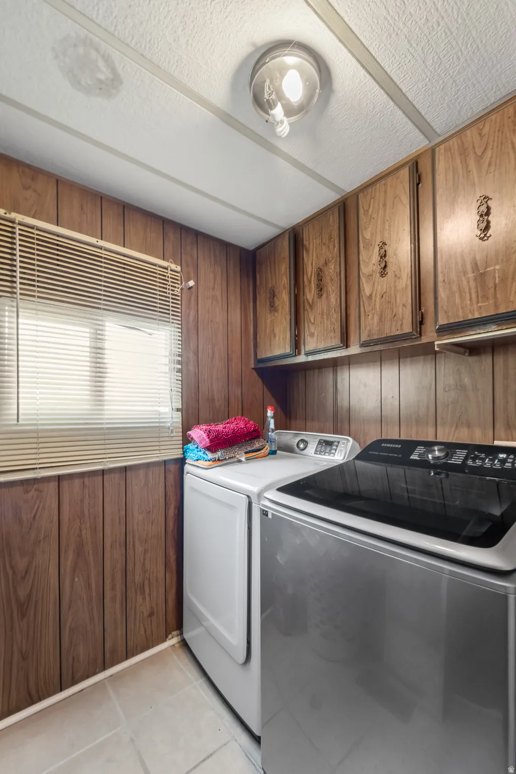 Dedicated laundry area with wood-finish wall paneling