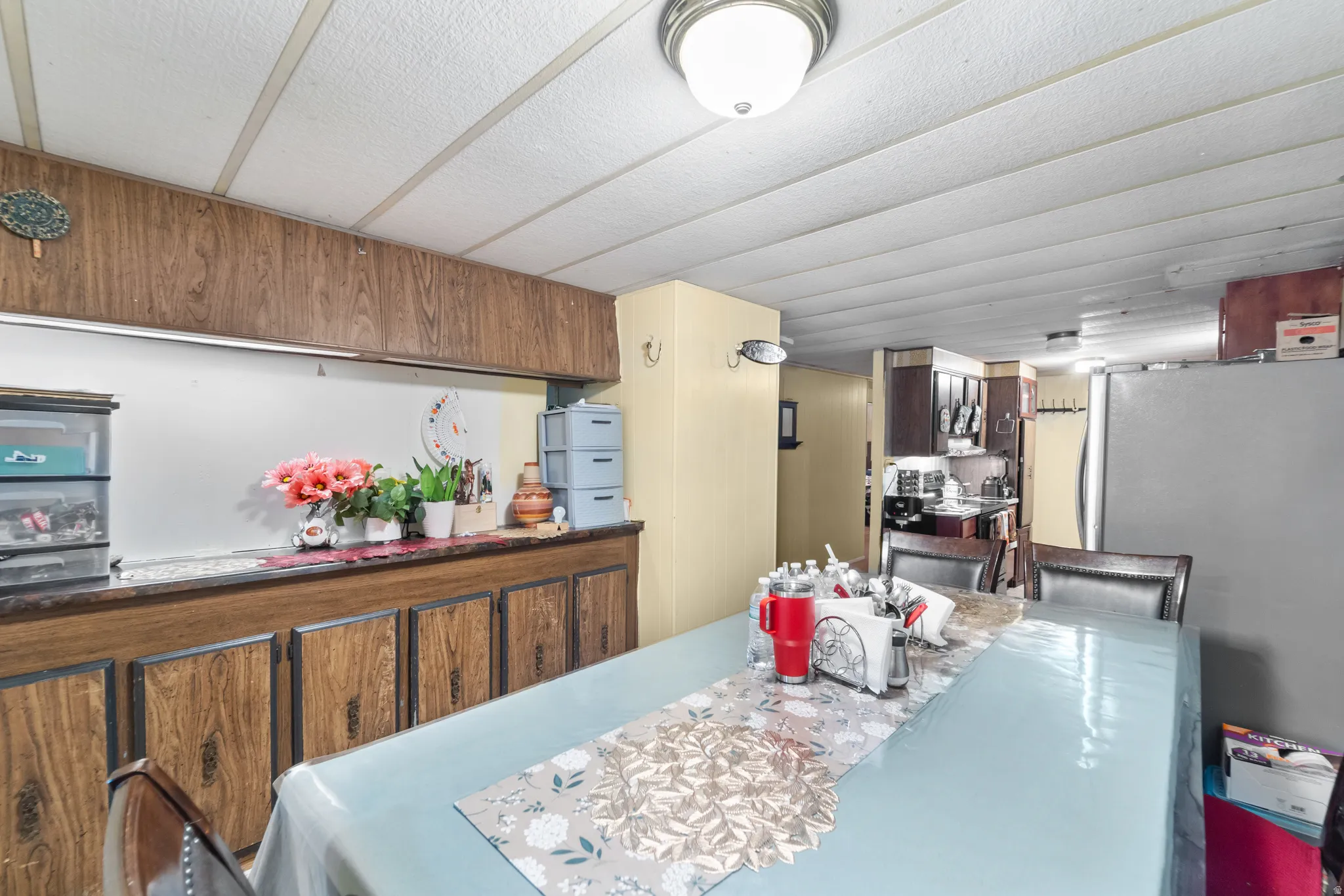 Dining area featuring a wood-finish built-in buffet with upper storage and a lower cabinetry run
