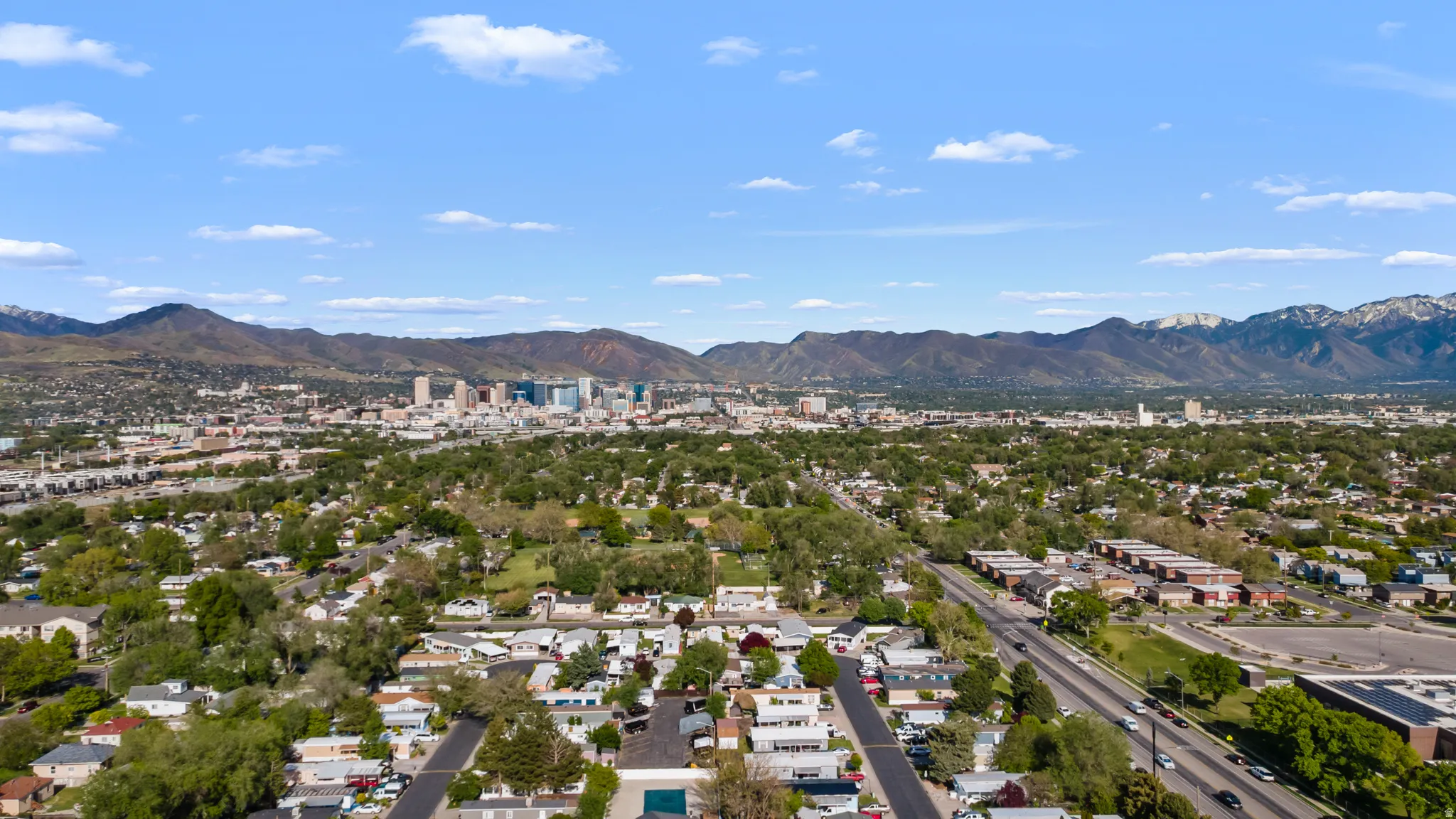 Aerial perspective showcasing an expansive urban landscape with a distant city skyline