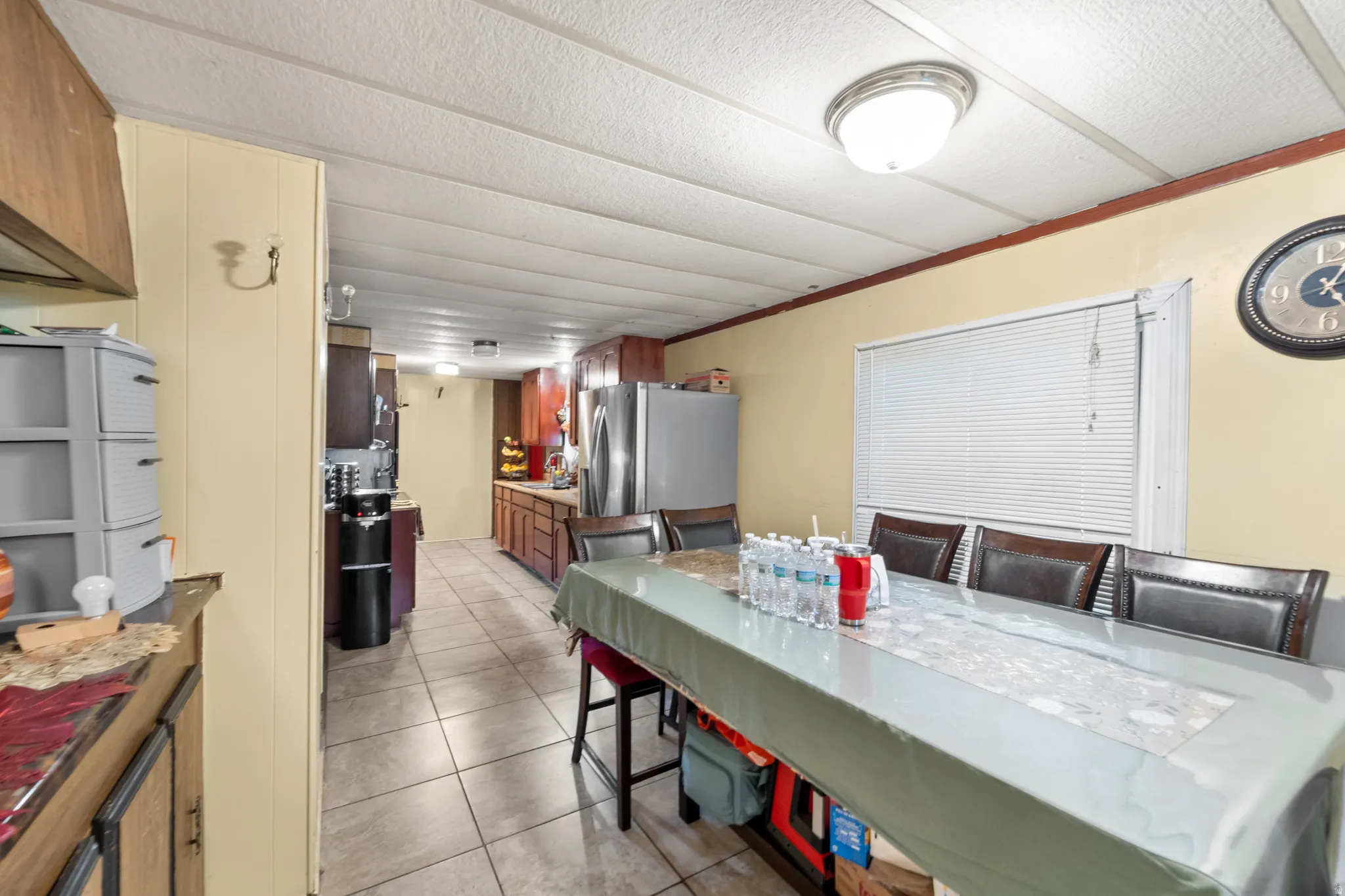 Dining area with a window featuring horizontal blinds
